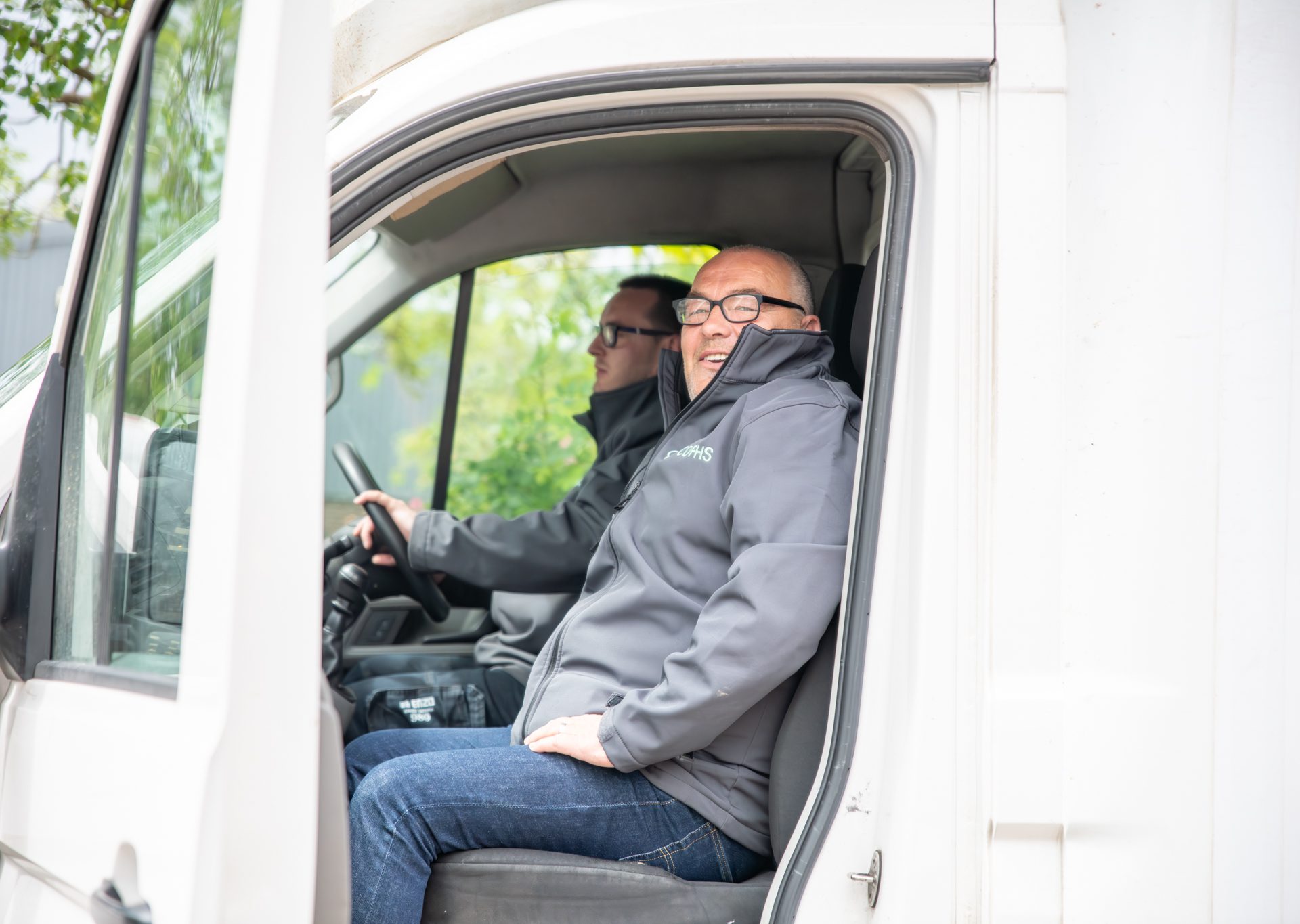 A photo showing a member of CDFHS's van crew in his van to collect furniture donations